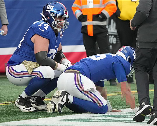East Rutherford, NJ -- November 24, 2024 -- Tommy DeVito of the Giants gets hit by Calijah Kancey of Tampa Bay after he threw a pass in the fourth quarter. DeVito was injured and came out of the game for one play as the Tampa Bay Buccaneers came to MetLife Stadium and defeated the New York Giants 30-7.