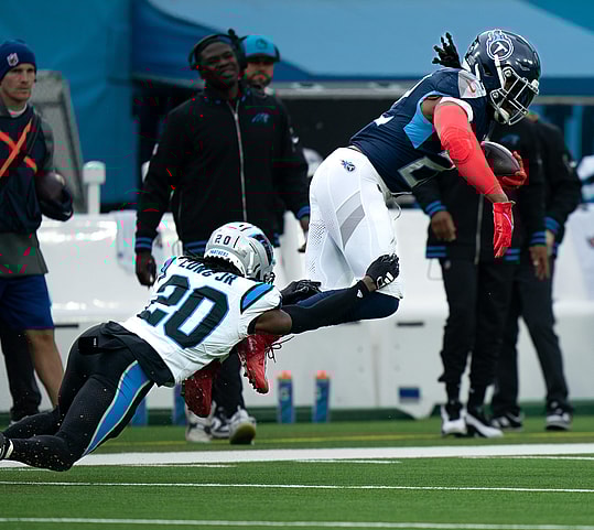 Carolina Panthers cornerback David Long Jr. (20) makes a tackle on Tennessee Titans running back Derrick Henry (22) during their game at Nissan Stadium in Nashville, Tenn., Sunday, Nov. 26, 2023.