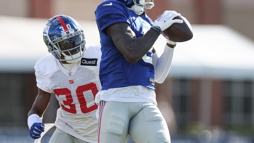 New York Giants wide receiver Parris Campbell (0) catches the ball in front of cornerback Darnay Holmes (30) during training camp at the Quest Diagnostics Training Facility