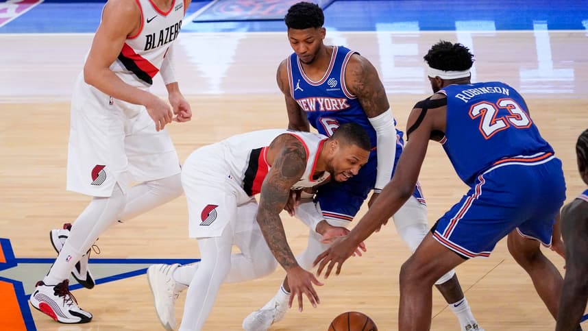 Portland Trail Blazers guard Damian Lillard (0) drives against New York Knicks center Mitchell Robinson (23) and guard Elfrid Payton (6) during the first half of an NBA basketball game, Saturday, Feb. 6, 2021, in New York