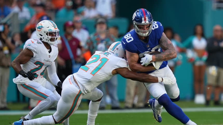 Miami Dolphins free safety Eric Rowe (21) tackles New York Giants tight end Kyle Rudolph (80) during the first half at Hard Rock Stadium