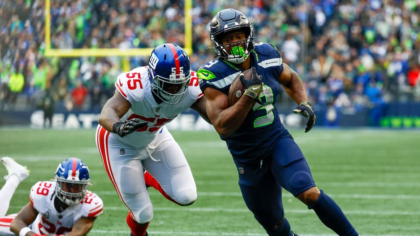 Seattle Seahawks running back Kenneth Walker III (9) escapes a tackle attempt by New York Giants linebacker Jihad Ward (55) to rush for a touchdown during the fourth quarter at Lumen Field