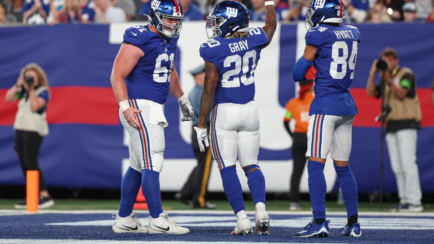 New York Giants running back Eric Gray (20) celebrates his rushing touchdown  with center John Michael Schmitz Jr. (61) and wide receiver Jalin Hyatt (84) during the first half against the Carolina Panthers at MetLife Stadium