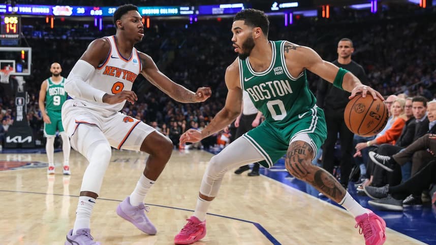 Boston Celtics forward Jayson Tatum (0) looks to drive past New York Knicks guard RJ Barrett (9) in the second quarter at Madison Square Garden