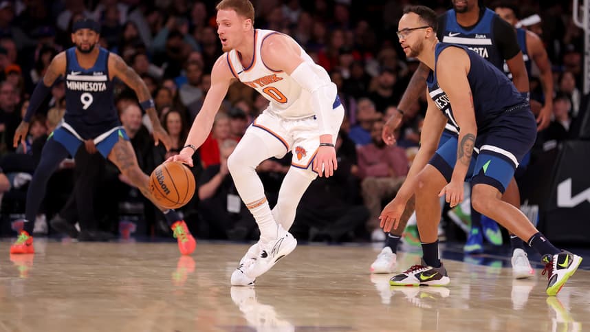 New York Knicks guard Donte DiVincenzo (0) controls the ball against Minnesota Timberwolves forward Kyle Anderson (1) during the second quarter at Madison Square Garden