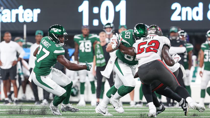 New York Jets running back Zonovan Knight (27) carries the ball as center Connor McGovern (60) blocks Tampa Bay Buccaneers linebacker K.J. Britt (52) during the first half at MetLife Stadium