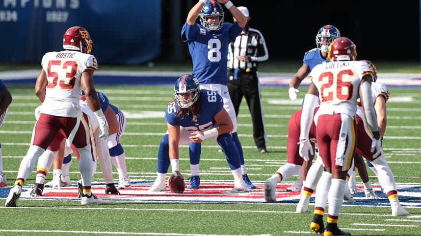New York Giants quarterback Daniel Jones (8) calls time out behind guard Nick Gates (65) as Washington Football Team linebacker Jon Bostic (53) and safety Landon Collins (26) defend during the second half at MetLife Stadium