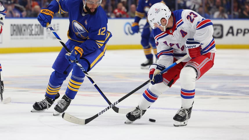 Buffalo Sabres left wing Jordan Greenway (12) and New York Rangers defenseman Adam Fox (23) go after a loose puck during the third period at KeyBank Center