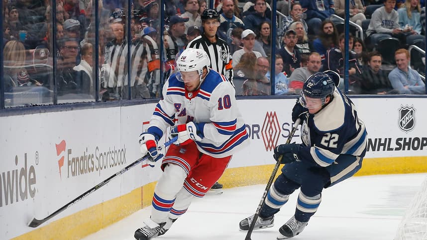 New York Rangers left wing Artemi Panarin (10) skates after a loose puck as Columbus Blue Jackets defenseman Jake Bean (22) trails the play during the third period at Nationwide Arena