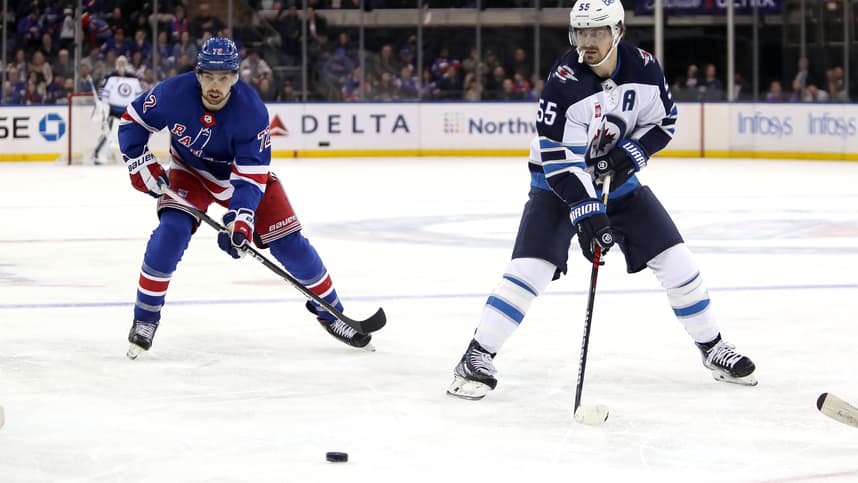 Winnipeg Jets center Mark Scheifele (55) passes the puck in front of New York Rangers center Filip Chytil (72) during the third period at Madison Square Garden