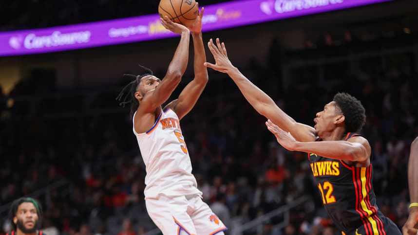 New York Knicks guard Immanuel Quickley (5) shoots over Atlanta Hawks forward De'Andre Hunter (12) in the second quarter at State Farm Arena