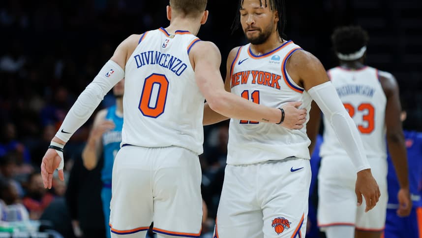 New York Knicks guard Jalen Brunson (11) embraces guard Donte DiVincenzo (0) during the first quarter against the Charlotte Hornets at Spectrum Center
