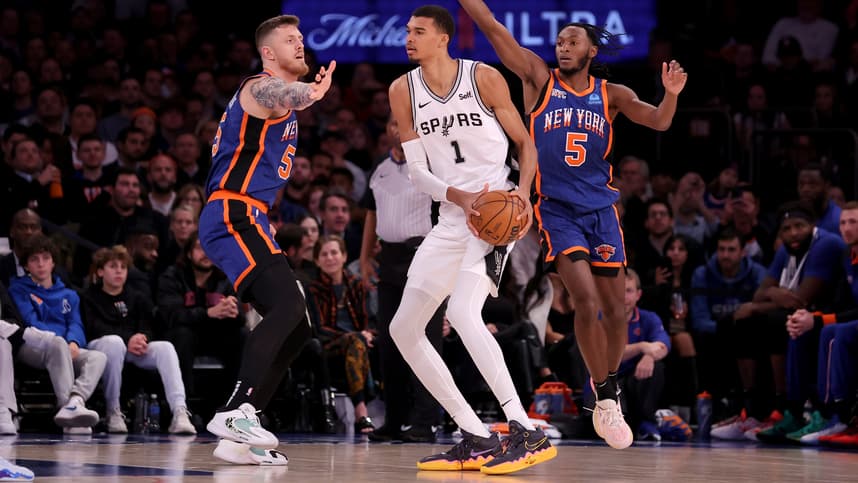 San Antonio Spurs center Victor Wembanyama (1) controls the ball against New York Knicks center Isaiah Hartenstein (55) and guard Immanuel Quickley (5) during the third quarter at Madison Square Garden