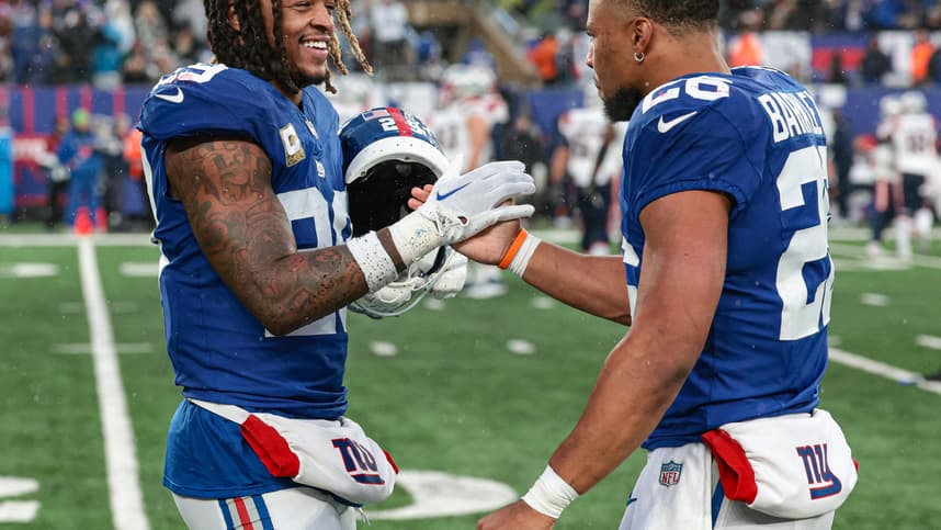 New York Giants safety Xavier McKinney (29) celebrates with running back Saquon Barkley (26) after a New England Patriots missed field goal during the fourth quarter at MetLife Stadium