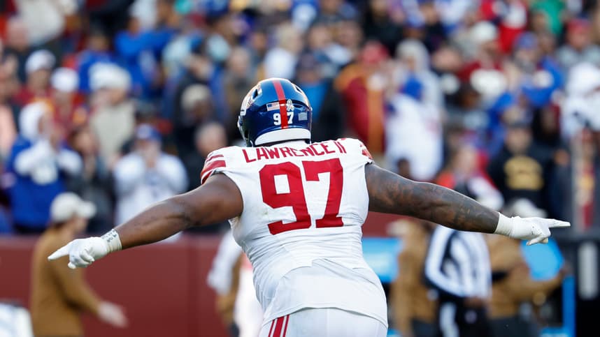 New York Giants defensive tackle Dexter Lawrence II (97) celebrates after an interception against the Washington Commanders during the fourth quarter at FedExField