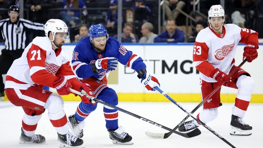 New York Rangers left wing Artemi Panarin (10) fights for the puck against Detroit Red Wings center Dylan Larkin (71) and defenseman Moritz Seider (53) during the third period at Madison Square Garden