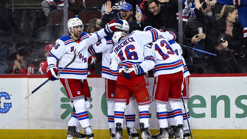 New York Rangers left wing Artemi Panarin (10) celebrates with teammates after scoring a goal against the New Jersey Devils during the third period at Prudential Center