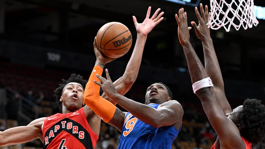 New York Knicks guard RJ Barrett (9) tries to shoot the ball as Toronto Raptors forwards Scottie Barnes (4) and OG Anunoby (3) defend in the first half at Scotiabank Arena