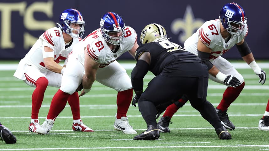New York Giants center John Michael Schmitz Jr. (61) snaps the ball to quarterback Tommy DeVito (15) during the first half against the New Orleans Saints at Caesars Superdome