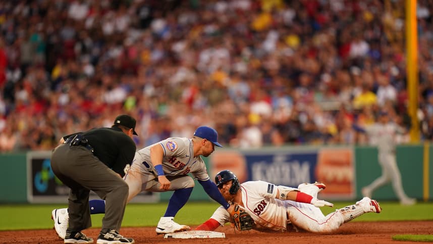Boston Red Sox designated hitter Justin Turner (2) safe at second with a double against New York Mets second baseman Danny Mendick (15) in the third inning at Fenway Park