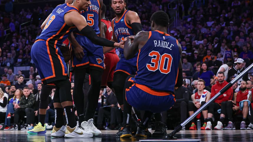 New York Knicks forward Julius Randle (30) is helped up by teammates after being injured during the second half against the Miami Heat at Madison Square Garden