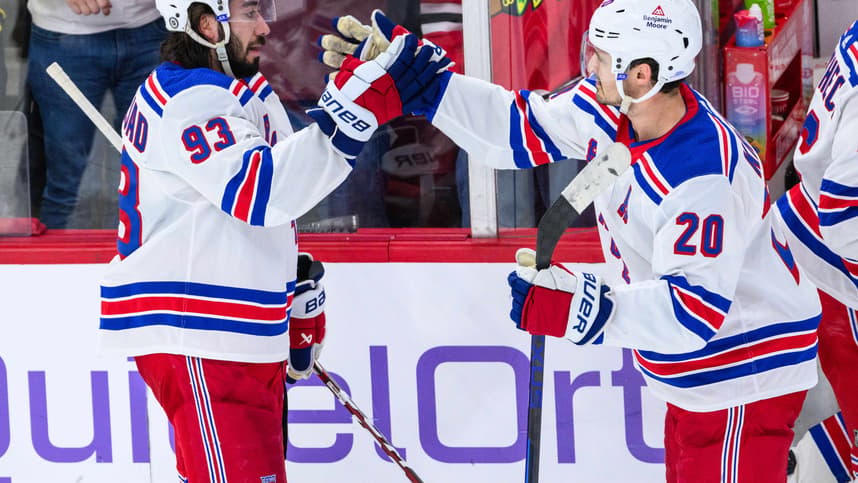 New York Rangers center Mika Zibanejad (93) celebrates with center Rem Pitlick (20) against the Chicago Blackhawks after the game at the United Center