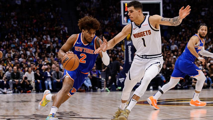 New York Knicks guard Miles McBride (2) drives to the basket against Denver Nuggets forward Michael Porter Jr. (1) in the fourth quarter at Ball Arena