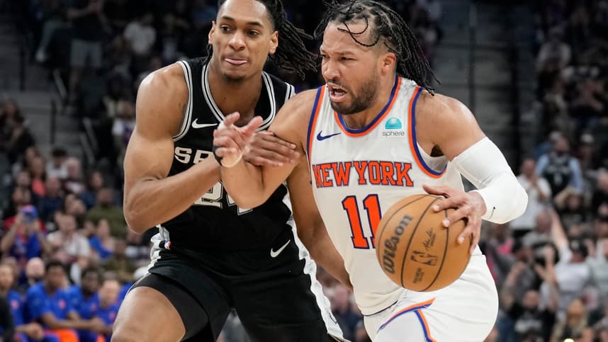 New York Knicks guard Jalen Brunson (11) drives to the basket while defended by San Antonio Spurs guard Devin Vassell (24) during overtime at Frost Bank Center