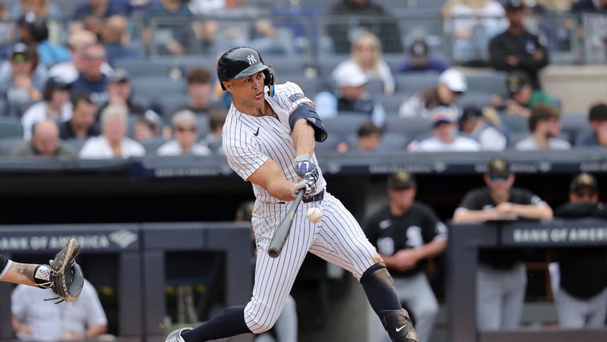May 18, 2024; Bronx, New York, USA; New York Yankees designated hitter Giancarlo Stanton (27) hits a solo home run against the Chicago White Sox during the third inning at Yankee Stadium. Mandatory Credit: Brad Penner-USA TODAY Sports
