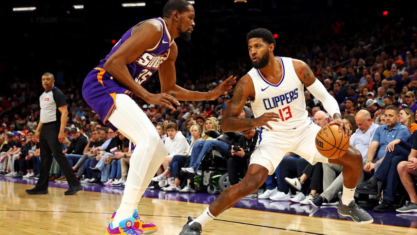 Apr 9, 2024; Phoenix, Arizona, USA;  (New York Knicks) LA Clippers forward Paul George (13) handles the ball against Phoenix Suns forward Kevin Durant (35) during the first quarter at Footprint Center. Mandatory Credit: Mark J. Rebilas-USA TODAY Sports
