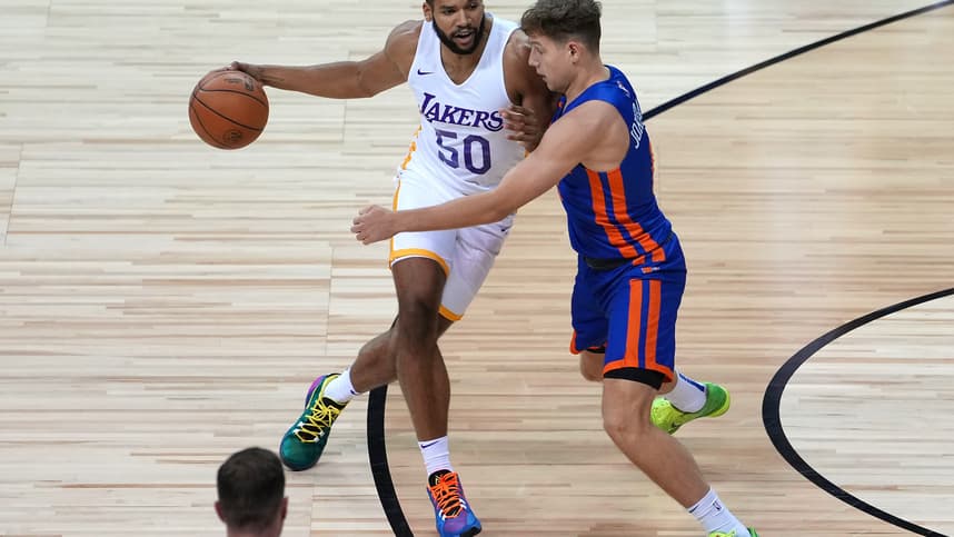 Aug 11, 2021; Las Vegas, Nevada, USA; Los Angeles Lakers forward Yoeli Childs (50) dribbles against New York Knicks guard Rokas Jokubaitis (0) during an NBA Summer League game at Thomas & Mack Center. Mandatory Credit: Stephen R. Sylvanie-USA TODAY Sports