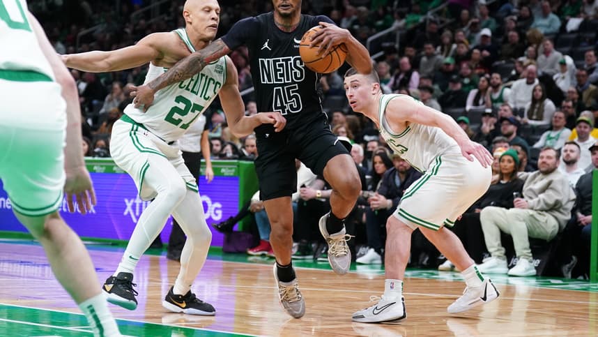Feb 14, 2024; Boston, Massachusetts, USA; Brooklyn Nets guard Keon Johnson (45) drives the ball against Boston Celtics guard Payton Pritchard (11) and guard Jordan Walsh (27) in the second half at TD Garden. Mandatory Credit: David Butler II-USA TODAY Sports