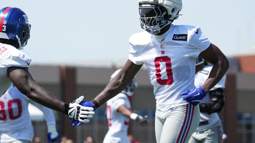 Jul 26, 2024; East Rutherford, NJ, USA; New York Giants linebacker Brian Burns (0) high fives New York Giants defensive tackle Rakeem Nunez-Roches (93) during training camp at Quest Diagnostics Training Center. Mandatory Credit: Lucas Boland-USA TODAY Sports