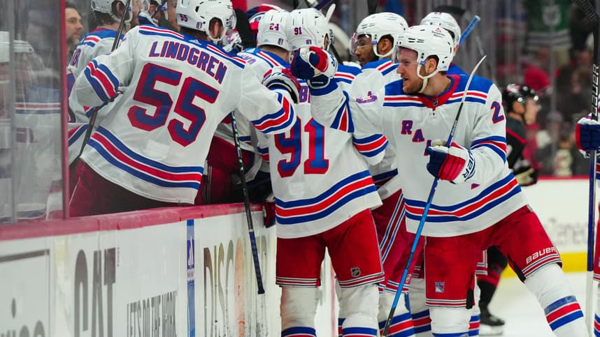 May 16, 2024; Raleigh, North Carolina, USA; New York Rangers defenseman Adam Fox (23) and defenseman Ryan Lindgren (55) celebrate center Barclay Goodrow (21) (not shown) goal against the Carolina Hurricanes during the third period in game six of the second round of the 2024 Stanley Cup Playoffs at PNC Arena. Mandatory Credit: James Guillory-USA TODAY Sports