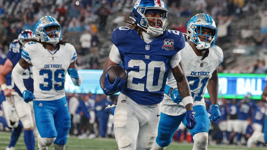Aug 8, 2024; East Rutherford, New Jersey, USA; New York Giants running back Eric Gray (20) scores a rushing touchdown in front of Detroit Lions cornerback Amik Robertson (21) and cornerback Morice Norris (39) during the first half at MetLife Stadium. Mandatory Credit: Vincent Carchietta-USA TODAY Sports