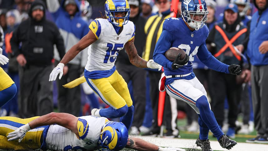 Dec 31, 2023; East Rutherford, New Jersey, USA; New York Giants safety Dane Belton (24) returns an interception as Los Angeles Rams tight end Tyler Higbee (89) and wide receiver Demarcus Robinson (15) pursue during the second half at MetLife Stadium. Mandatory Credit: Vincent Carchietta-USA TODAY Sports