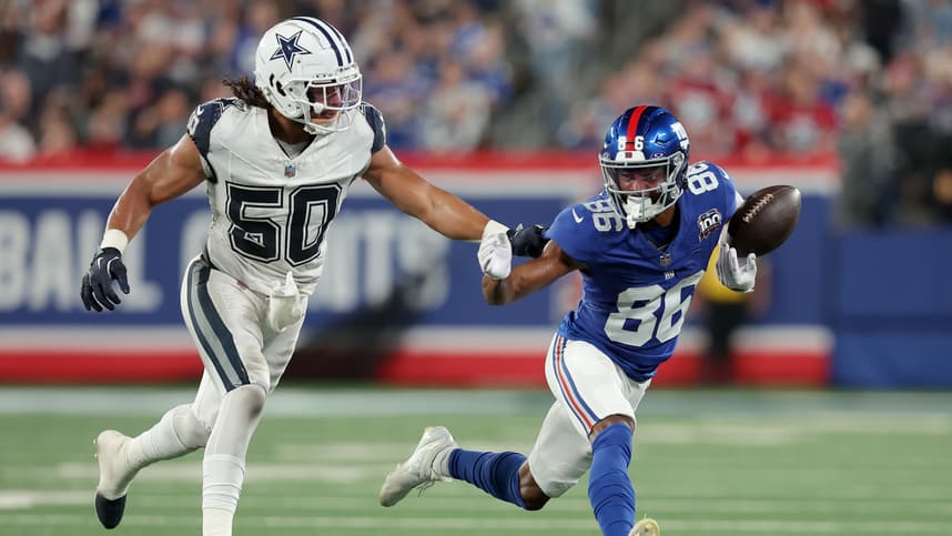Sep 26, 2024; East Rutherford, New Jersey, USA; New York Giants wide receiver Darius Slayton (86) bobbles the ball as he runs against Dallas Cowboys linebacker Eric Kendricks (50) during the second quarter at MetLife Stadium. Mandatory Credit: Brad Penner-Imagn Images