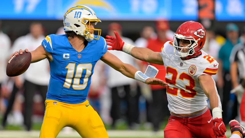 Sep 29, 2024; Inglewood, California, USA;  Los Angeles Chargers quarterback Justin Herbert (10) throws an incomplete pas as is pressured by Kansas City Chiefs linebacker Drue Tranquill (23) at SoFi Stadium. Mandatory Credit: Jayne Kamin-Oncea-Imagn Images