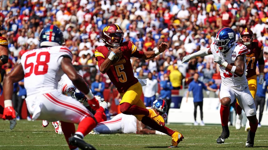 Sep 15, 2024; Landover, Maryland, USA; Washington Commanders quarterback Jayden Daniels (5) runs the ball against New York Giants safety Tyler Nubin (31) and linebacker Bobby Okereke (58) during the fourth quarter at Commanders Field. Mandatory Credit: Peter Casey-Imagn Images