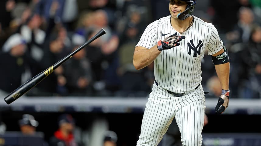 Oct 14, 2024; Bronx, New York, USA; New York Yankees designated hitter Giancarlo Stanton (27) hits a solo home run during the seventh inning against the Cleveland Guardians in game one of the ALCS for the 2024 MLB Playoffs at Yankee Stadium. Mandatory Credit: Brad Penner-Imagn Images