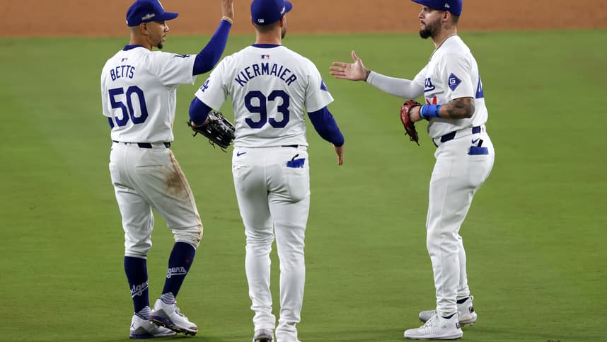 Oct 13, 2024; Los Angeles, California, USA; Los Angeles Dodgers shortstop Mookie Betts (50) reacts with outfielder Andy Pages (44) and outfielder Kevin Kiermaier (93)  teammates after the ninth inning during game one of the NLCS for the 2024 MLB Playoffs at Dodger Stadium.  Mandatory Credit: Jason Parkhurst-Imagn Images