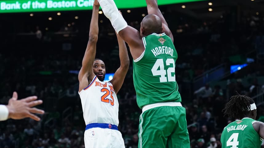 Oct 22, 2024; Boston, Massachusetts, USA; New York Knicks forward Mikal Bridges (25) shoots against Boston Celtics center Al Horford (42) in the second half at TD Garden. Mandatory Credit: David Butler II-Imagn Images