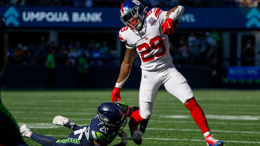 Oct 6, 2024; Seattle, Washington, USA; New York Giants running back Tyrone Tracy Jr. (29) breaks a tackle attempt by Seattle Seahawks safety Julian Love (20) during the second quarter at Lumen Field. Mandatory Credit: Joe Nicholson-Imagn Images