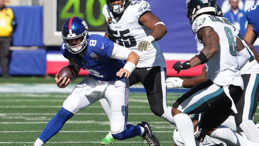 Oct 20, 2024; East Rutherford, New Jersey, USA;  New York Giants quarterback Daniel Jones (8) runs against the Philadelphia Eagles during the first half at MetLife Stadium. Mandatory Credit: Robert Deutsch-Imagn Images