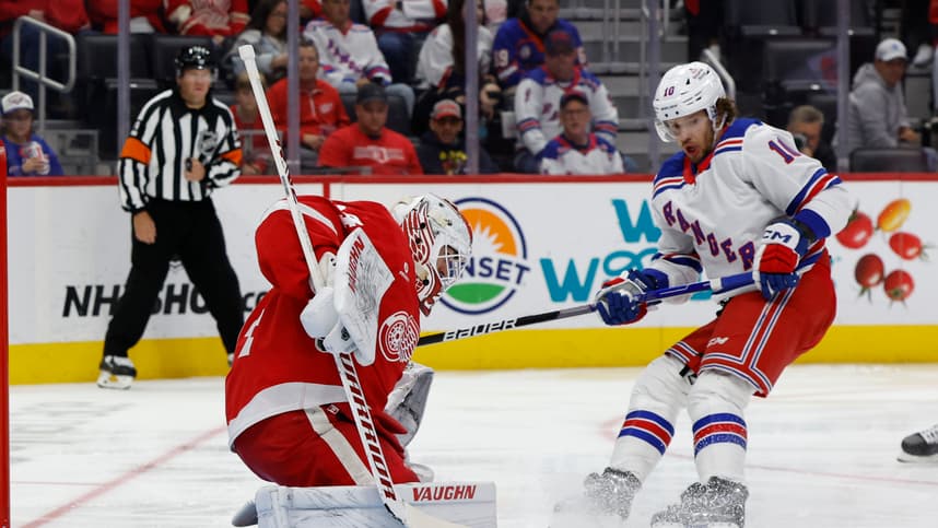 Oct 17, 2024; Detroit, Michigan, USA;  Detroit Red Wings goaltender Alex Lyon (34) makes a save on New York Rangers left wing Artemi Panarin (10) in the third period at Little Caesars Arena. Mandatory Credit: Rick Osentoski-Imagn Images