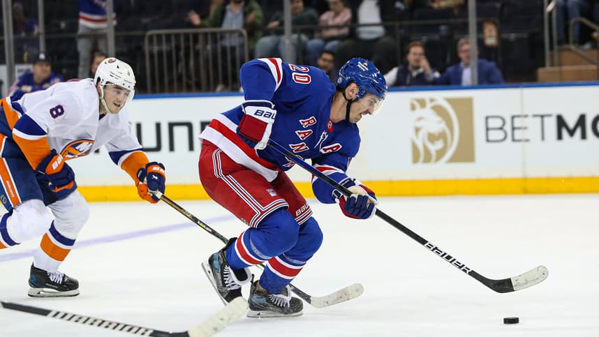 Sep 24, 2024; New York, New York, USA; New York Rangers left wing Chris Kreider (20) scores an empty-net goal while New York Islanders defenseman Noah Dobson (8) chases during the third period at Madison Square Garden. Mandatory Credit: Danny Wild-Imagn Images
