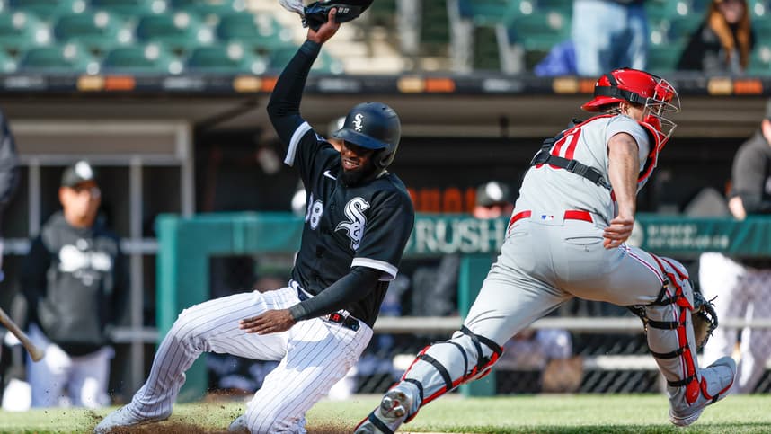 Apr 18, 2023; Chicago, Illinois, USA; Chicago White Sox center fielder Luis Robert Jr. (88) scores against Philadelphia Phillies catcher J.T. Realmuto (10) during the third inning of game one of the doubleheader at Guaranteed Rate Field. Mandatory Credit: Kamil Krzaczynski-Imagn Images
