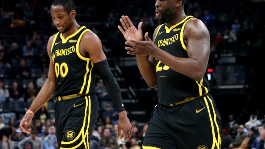 Jan 15, 2024; Memphis, Tennessee, USA; Golden State Warriors forward Jonathan Kuminga (00) and Golden State Warriors forward Draymond Green (23) walk to the bench at the end of the first quarter against the Memphis Grizzlies  at FedExForum. Mandatory Credit: Petre Thomas-Imagn Images
