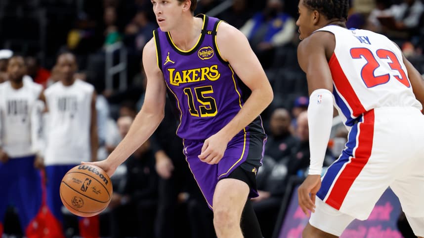 Nov 4, 2024; Detroit, Michigan, USA; Los Angeles Lakers guard Austin Reaves (15) dribbles defended by Detroit Pistons guard Jaden Ivey (23) in the first half at Little Caesars Arena. Mandatory Credit: Rick Osentoski-Imagn Images
