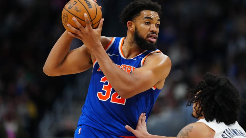 Nov 25, 2024; Denver, Colorado, USA; New York Knicks center Karl-Anthony Towns (32) controls the ball over Denver Nuggets guard Julian Strawther (3) in the second half at Ball Arena. Mandatory Credit: Ron Chenoy-Imagn Images